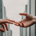 One hand approaching another hand to give shake hand
